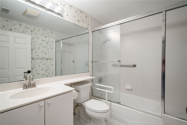 full bathroom featuring tile patterned floors, vanity, enclosed tub / shower combo, and toilet