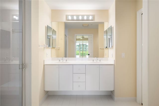 bathroom with tile patterned floors, vanity, and walk in shower