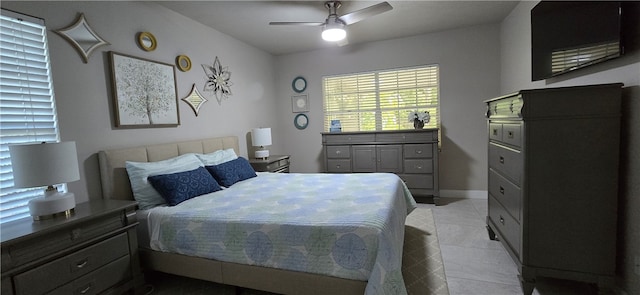 bedroom with ceiling fan and light tile patterned flooring