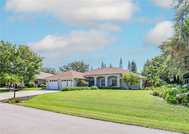 view of front of property featuring a garage and a front yard