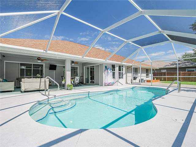 view of pool with a lanai, ceiling fan, and a patio area