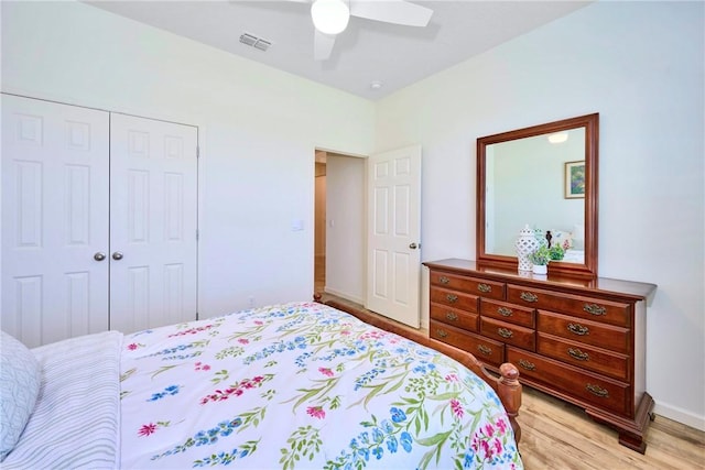 bedroom featuring light wood finished floors, visible vents, baseboards, a closet, and a ceiling fan