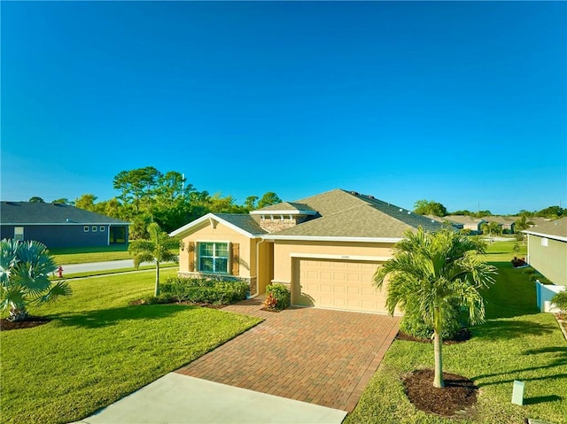 view of front facade featuring a front yard, roof with shingles, an attached garage, stucco siding, and decorative driveway