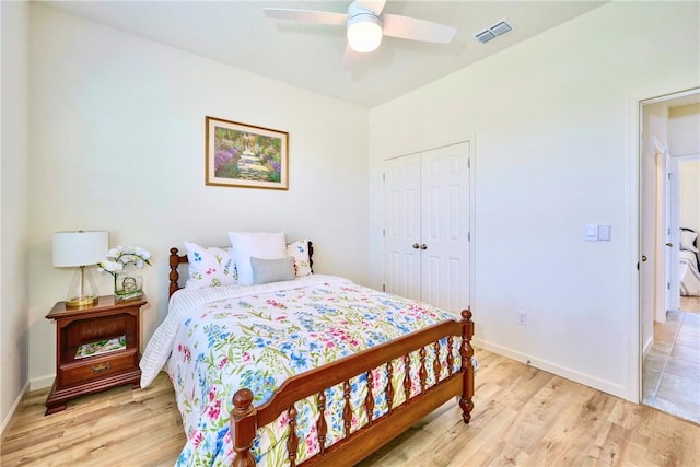 bedroom featuring baseboards, visible vents, a closet, and light wood-type flooring