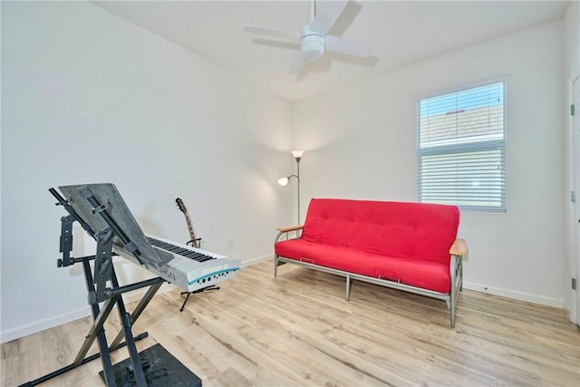 sitting room featuring a ceiling fan, wood finished floors, and baseboards