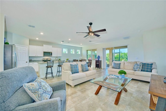 living room with recessed lighting, visible vents, and ceiling fan