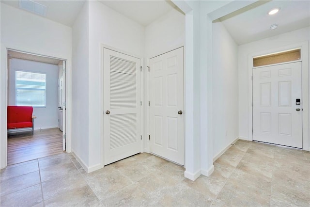 entrance foyer with visible vents, recessed lighting, and baseboards