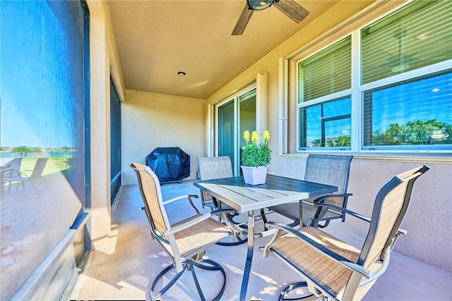 view of patio with outdoor dining space and a ceiling fan