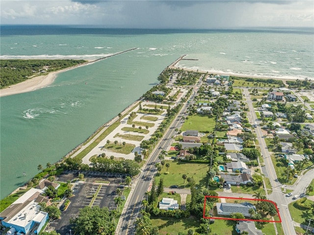 bird's eye view with a water view and a beach view