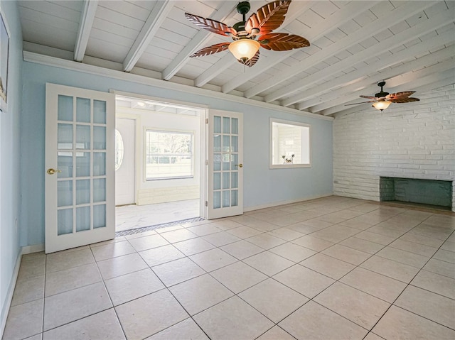 interior space with lofted ceiling with beams, french doors, light tile patterned flooring, a brick fireplace, and ceiling fan