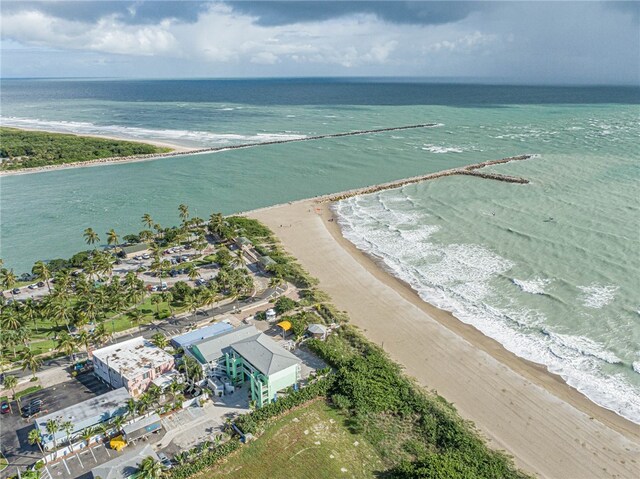 aerial view featuring a view of the beach and a water view