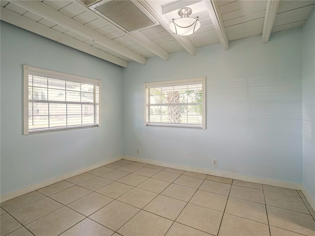 spare room with beam ceiling, light tile patterned floors, and wood ceiling