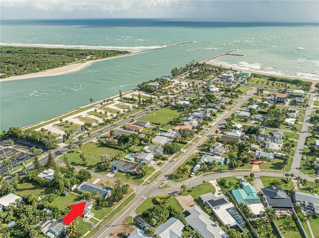 bird's eye view with a water view and a beach view