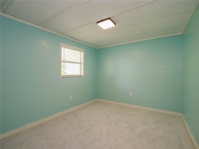 carpeted empty room featuring ornamental molding