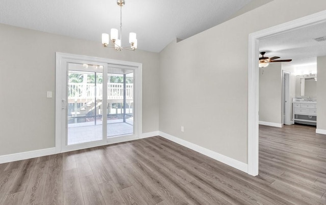 841 Carnation Dr, Sebastian, FL 32958 - unfurnished dining area with wood finished floors, a chandelier, baseboards, and a ceiling fan