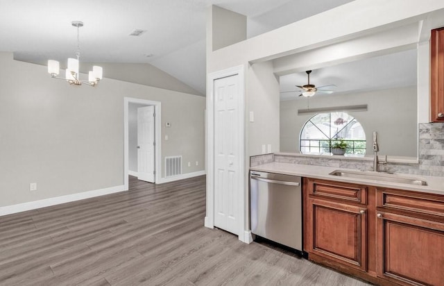 841 Carnation Dr, Sebastian, FL 32958 - kitchen with a sink, dishwasher, light wood finished floors, a chandelier, and vaulted ceiling