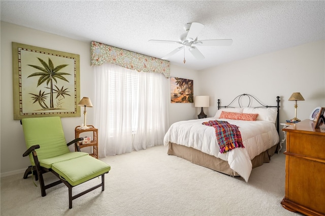 carpeted bedroom with a textured ceiling and ceiling fan