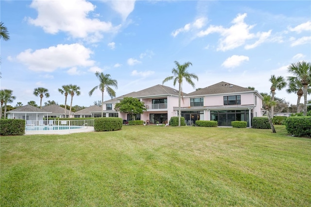 back of property featuring a lawn