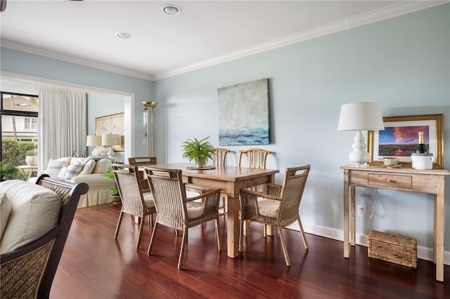 dining area with dark hardwood / wood-style floors and crown molding