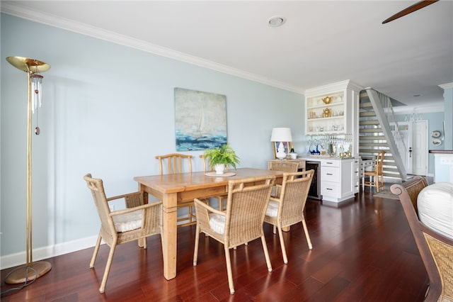 dining space with crown molding, dark hardwood / wood-style flooring, and indoor bar