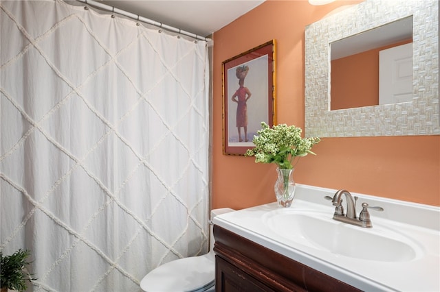 bathroom featuring toilet and vanity