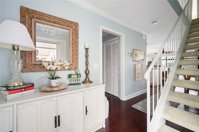 corridor with an inviting chandelier, ornamental molding, and dark hardwood / wood-style flooring