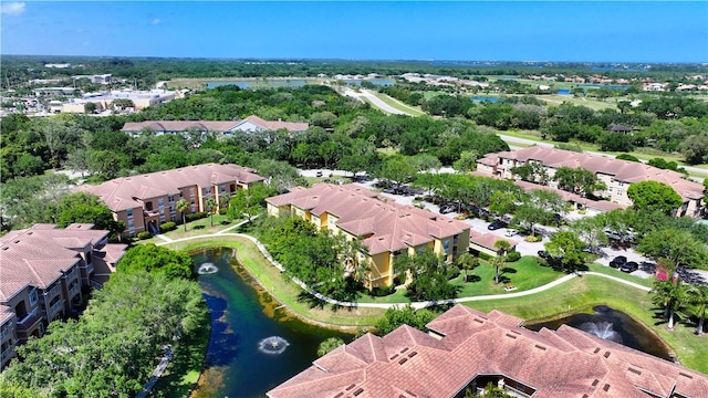 aerial overview of property's location with a nearby body of water and nearby suburban area
