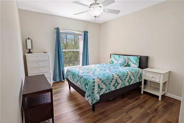 bedroom with wood finished floors, baseboards, and ceiling fan