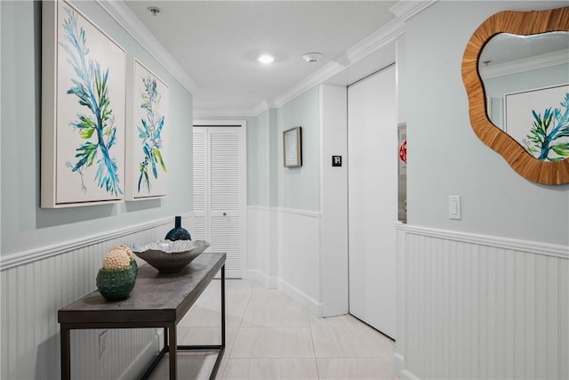 corridor with crown molding and light tile patterned flooring