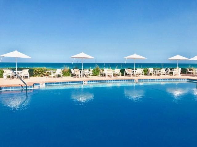 view of pool with a water view