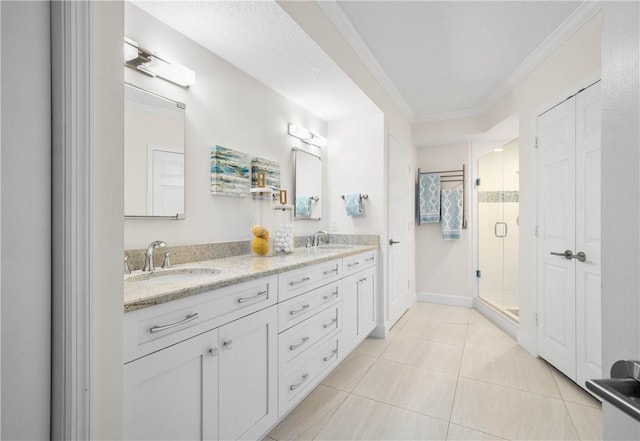 bathroom with tile patterned floors, ornamental molding, walk in shower, and vanity