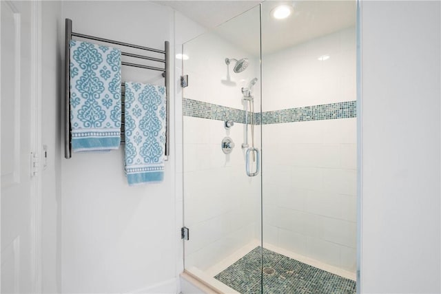 bathroom featuring a shower with shower door