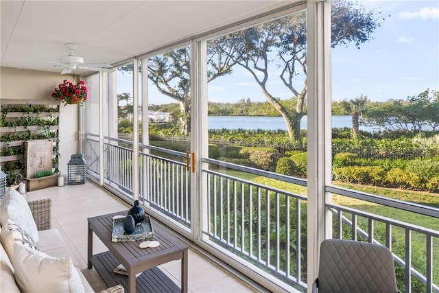 sunroom / solarium featuring ceiling fan and a water view