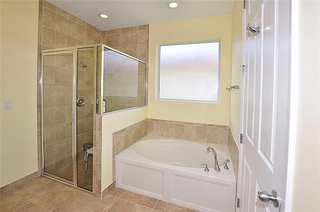 bathroom with tile patterned flooring and separate shower and tub