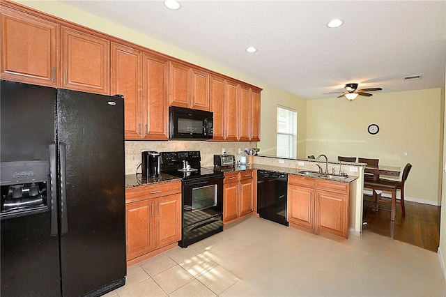 kitchen featuring ceiling fan, sink, kitchen peninsula, light tile patterned flooring, and black appliances