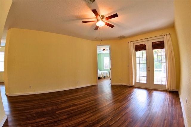 spare room with a textured ceiling, ceiling fan, french doors, and dark hardwood / wood-style floors