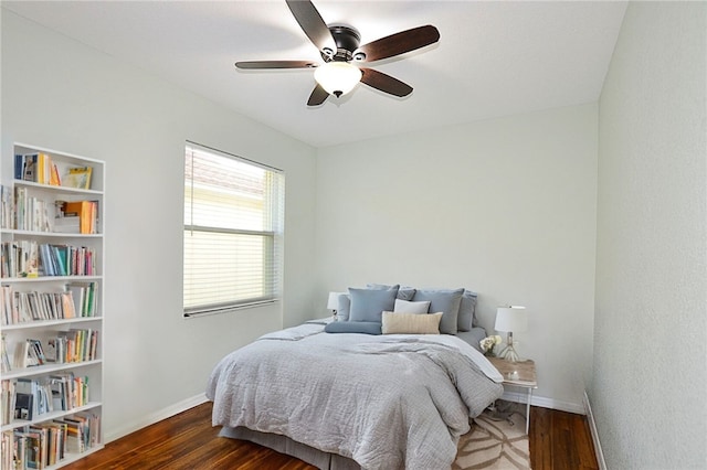 bedroom with ceiling fan and dark hardwood / wood-style flooring