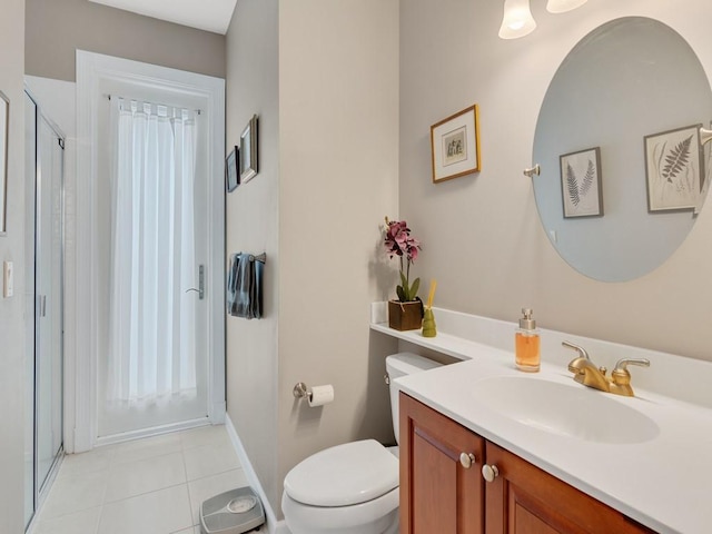 bathroom with toilet, vanity, tile patterned floors, and walk in shower