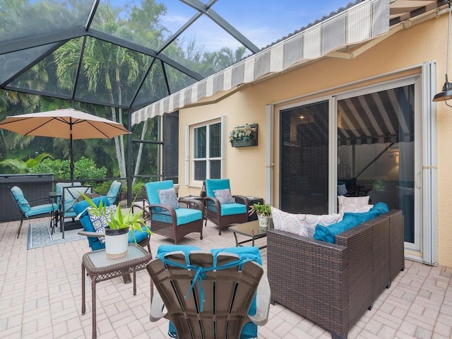 view of patio / terrace featuring outdoor lounge area, a hot tub, and glass enclosure