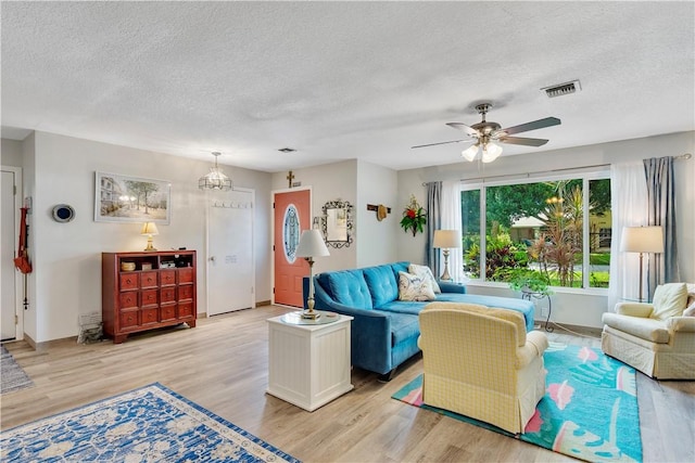 1385 14th Ave, Vero Beach, FL 32960 - living area featuring a textured ceiling, light wood-type flooring, and ceiling fan