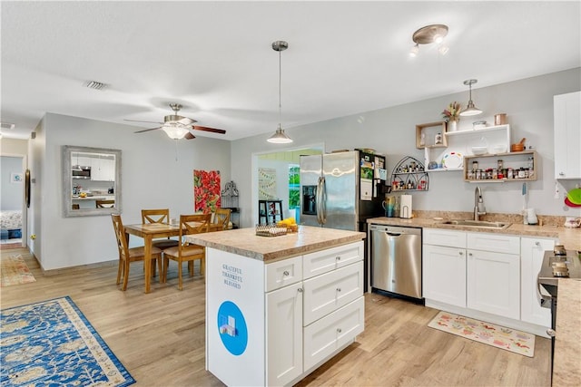1385 14th Ave, Vero Beach, FL 32960 - kitchen with stainless steel appliances, light wood-style flooring, a ceiling fan, and light countertops