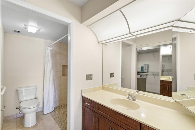 bathroom featuring tile patterned flooring, toilet, tiled shower, and visible vents