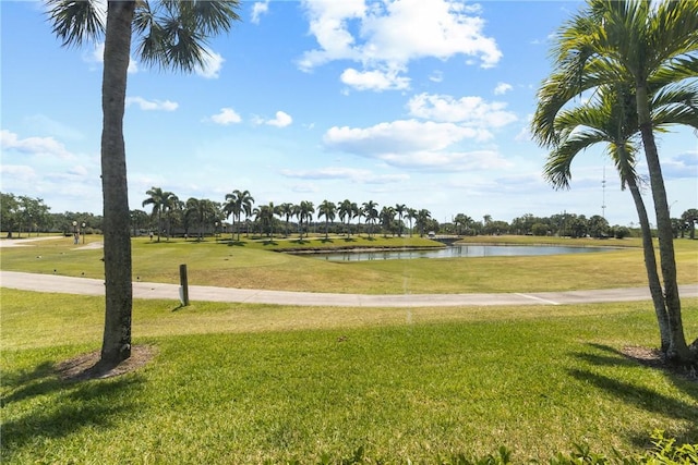 surrounding community with a yard, a water view, and view of golf course