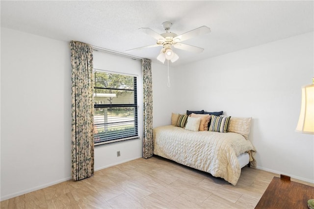 bedroom featuring baseboards and ceiling fan
