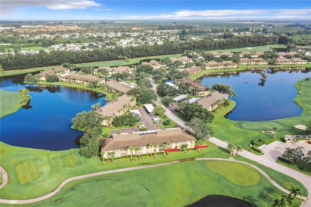 aerial view featuring a water view, view of golf course, and a residential view