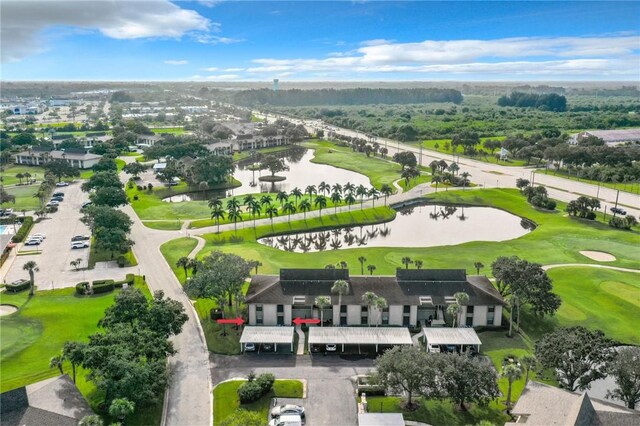 bird's eye view with a water view and view of golf course