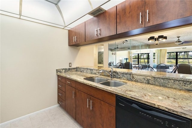 kitchen featuring light stone countertops, a sink, black dishwasher, baseboards, and visible vents