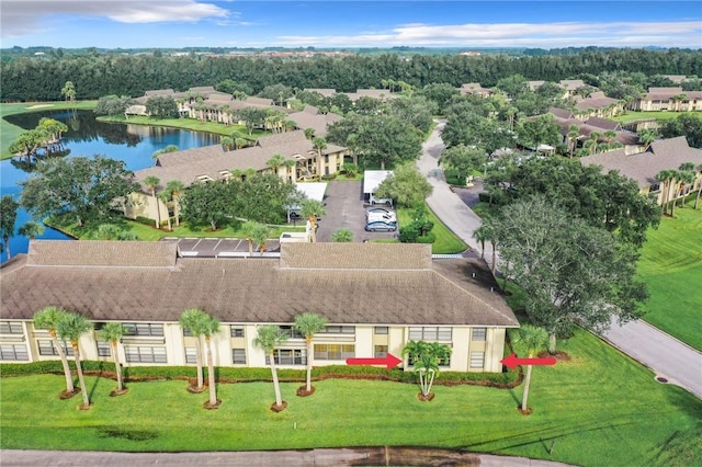 drone / aerial view featuring a water view and a residential view