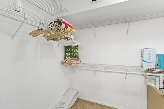 walk in closet featuring carpet flooring