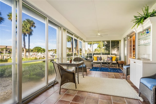 sunroom / solarium featuring ceiling fan